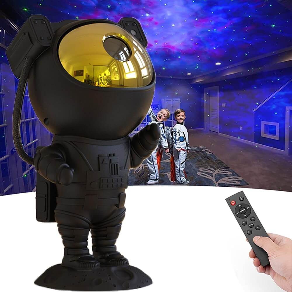 Astronaut Galaxy Projector night light illuminating a room with starry nebula ceiling, kids in space suits in the background, remote control in hand.