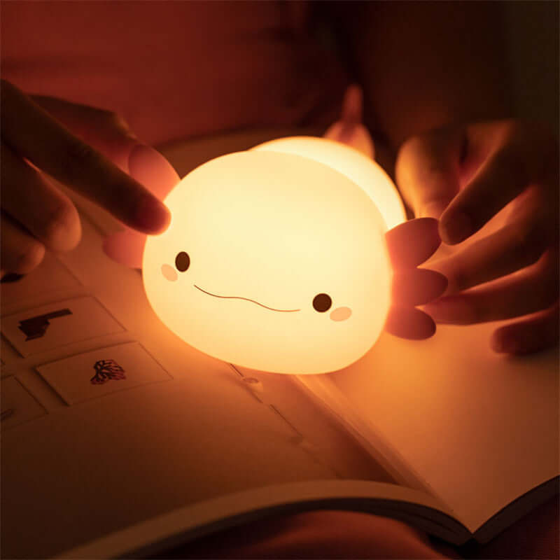 Cozy Squishy Salamander Lamp glowing warmly in the dark, perfect for bedtime reading and setting a relaxing ambiance.