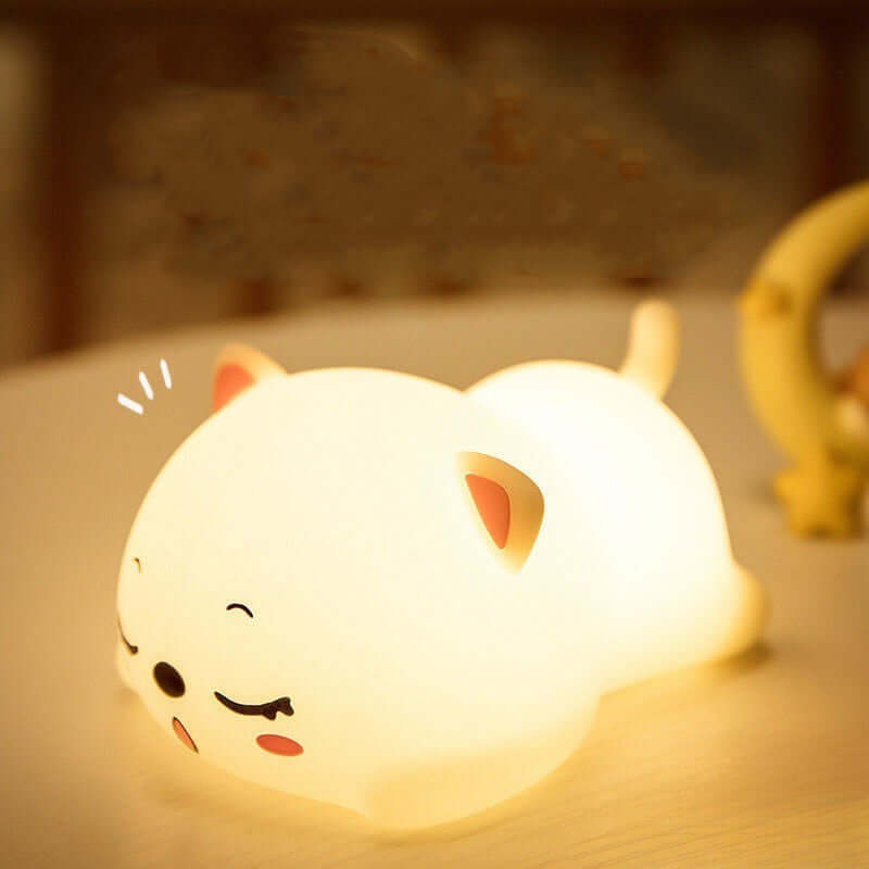 Adorable squishy cat lamp glowing softly on a table, perfect for creating a cozy atmosphere in any room.