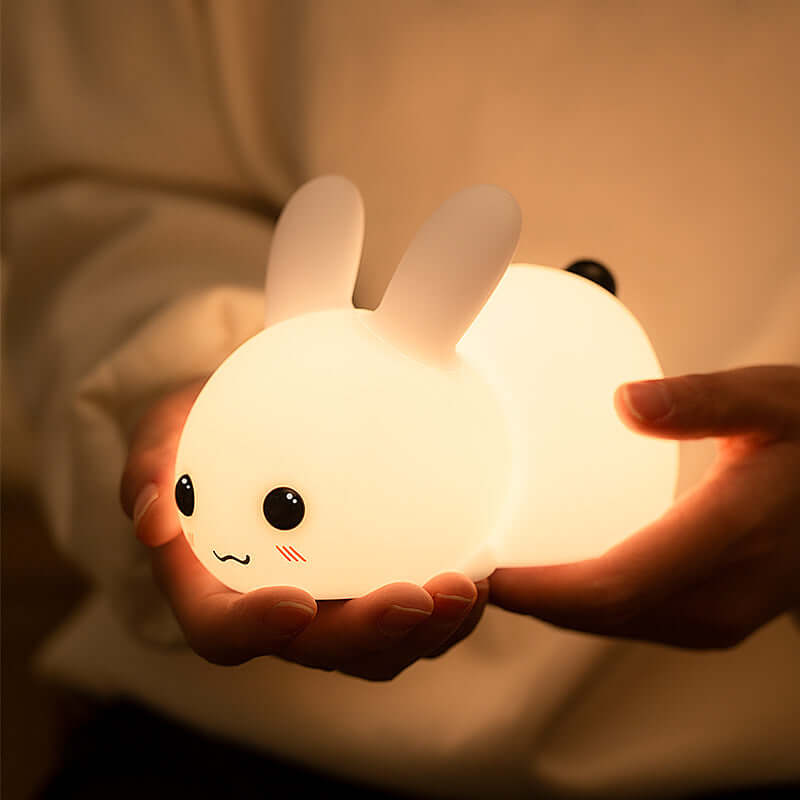 Soft glowing Squishy Rabbit Lamp held gently in hands, perfect for cozy and cute ambient lighting.